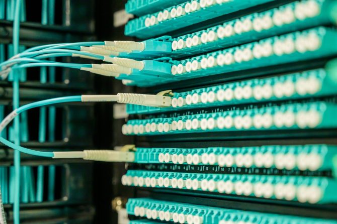 Fiber patch cords connected to a high-density patch panel in a building distribution frame