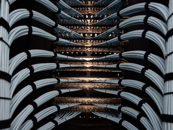 Neatly dressed horizontal cabling looms entering a rack row