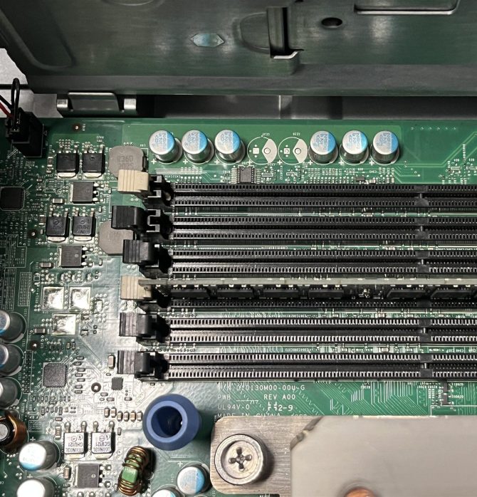 Server motherboard memory slots opened during a memory expansion, one module seated