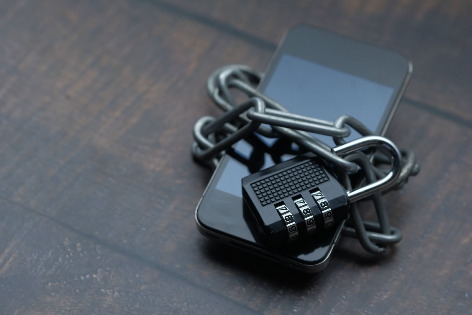 Smartphone wrapped in a chain and padlock, representing data protection