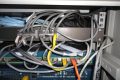 Rack before tidy-up: unmanaged patch cords looping over a patch panel and switches, the condition a hygiene pass corrects