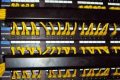 Front of a network rack with labeled copper patch panels, yellow patch leads and horizontal cable managers