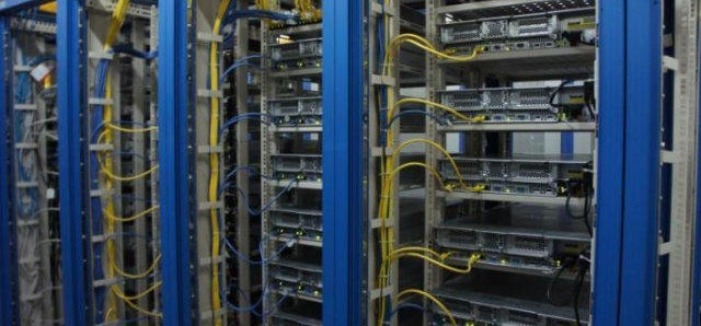 Server room rack row with vertically routed patch cabling and rack-mounted servers